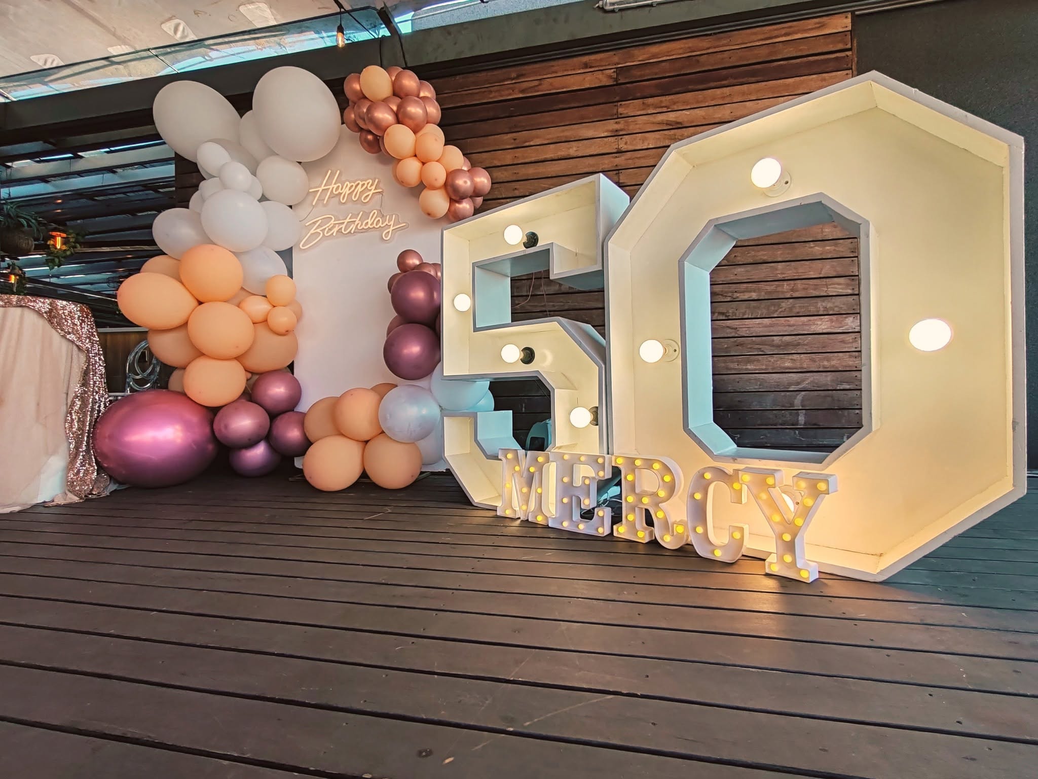 Balloon garland and giant 50 marquee numbers set up for a 50th birthday