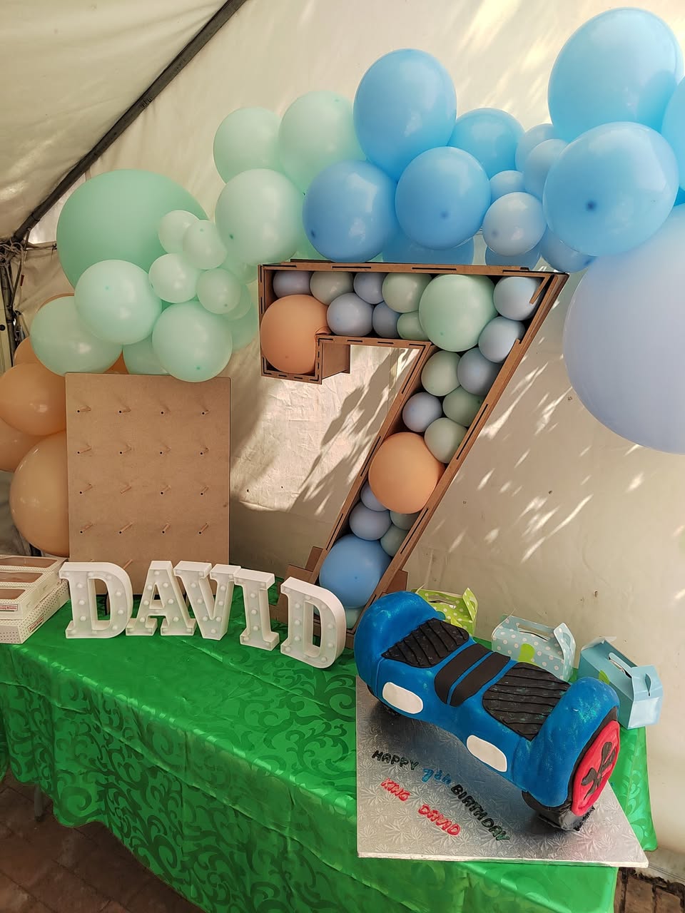 Giant balloon number seven with a name sign for a boy's 7th birthday