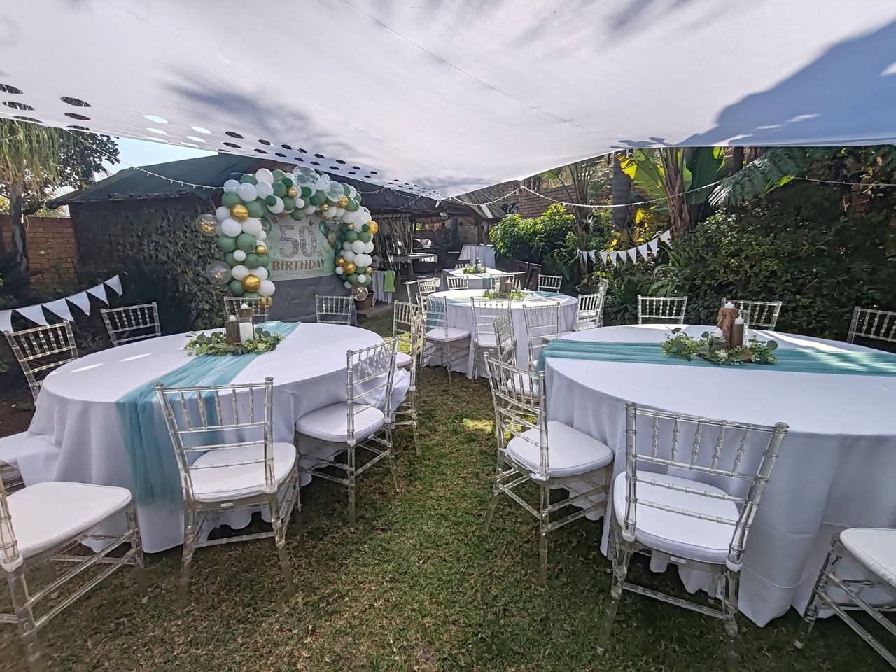 Garden marquee with dressed round tables and chairs