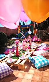 Picnic-style pamper party with cushions and balloons
