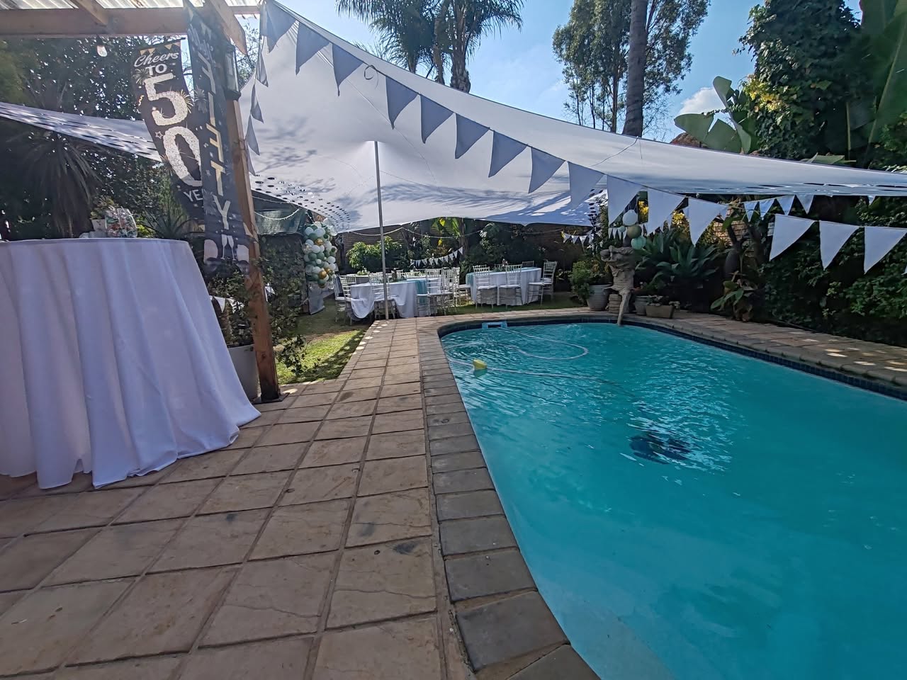 Poolside marquee with bunting and dressed tables
