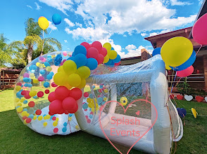 Clear bubble house decorated with rainbow balloons